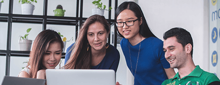 Team talking about work on laptop